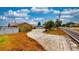 Wide shot of the yellow home's driveway next to the road with landscaping around the circle at 108 Lake Howard Dr Nw, Winter Haven, FL 33880
