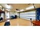 Spacious garage with a painted floor, storage and an open door leading inside the residence at 108 Lake Howard Dr Nw, Winter Haven, FL 33880