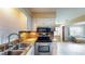 Updated kitchen featuring stainless steel oven, granite counters, and tile floors at 108 Lake Howard Dr Nw, Winter Haven, FL 33880