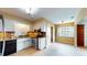 Well-lit kitchen features tile floors, stainless steel appliances, and granite countertops at 108 Lake Howard Dr Nw, Winter Haven, FL 33880
