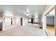 Bright living room featuring carpet flooring, ceiling fan, and open layout, with windows providing natural light at 108 Lake Howard Dr Nw, Winter Haven, FL 33880