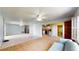 Spacious living room with both carpet and tile flooring, complemented by a ceiling fan and ample lighting at 108 Lake Howard Dr Nw, Winter Haven, FL 33880