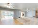 Open-concept living area with access to the screened pool area and water views through sliding glass doors at 108 Lake Howard Dr Nw, Winter Haven, FL 33880