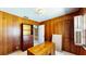 Office featuring a wood paneled wall, neutral carpet and vintage furniture at 108 Lake Howard Dr Nw, Winter Haven, FL 33880