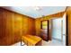 Office featuring a wood paneled wall, neutral carpet and vintage furniture at 108 Lake Howard Dr Nw, Winter Haven, FL 33880