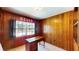 Office featuring a wood paneled wall, secure window and vintage furniture at 108 Lake Howard Dr Nw, Winter Haven, FL 33880