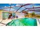 Enclosed pool area with a lake view and chairs at 108 Lake Howard Dr Nw, Winter Haven, FL 33880