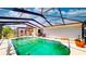 In-ground pool with screened enclosure and outdoor seating, creating a perfect space for outdoor enjoyment at 108 Lake Howard Dr Nw, Winter Haven, FL 33880