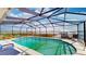 A stunning enclosed pool with chairs and a waterfront view at 108 Lake Howard Dr Nw, Winter Haven, FL 33880