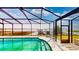 An enclosed pool with steel steps and a beautiful lake view at 108 Lake Howard Dr Nw, Winter Haven, FL 33880