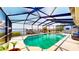 Sparkling in-ground pool with screened enclosure and lake views, perfect for relaxation and entertainment at 108 Lake Howard Dr Nw, Winter Haven, FL 33880