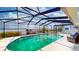 A beautiful enclosed pool featuring a lovely waterfront view at 108 Lake Howard Dr Nw, Winter Haven, FL 33880