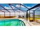 A well-maintained enclosed pool with a waterfront view at 108 Lake Howard Dr Nw, Winter Haven, FL 33880