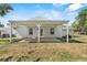 A covered patio extends from the rear of the home into a backyard at 1103 W Dixie Ave, Plant City, FL 33563