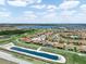 Aerial view of a planned community with ponds and lush green landscaping at 1104 Sawgrass Dr, Winter Haven, FL 33884