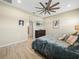 Inviting bedroom features wood-look floors, ceiling fan, and ensuite bathroom access at 1104 Sawgrass Dr, Winter Haven, FL 33884
