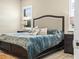 Comfortable bedroom with natural light from windows and a ceiling fan at 1104 Sawgrass Dr, Winter Haven, FL 33884
