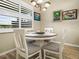Bright dining area features natural light from the window with white shutters and views at 1104 Sawgrass Dr, Winter Haven, FL 33884