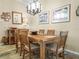 A formal dining room with a wooden table and chairs, carpet, and artwork on the walls at 1104 Sawgrass Dr, Winter Haven, FL 33884