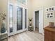 An open foyer featuring a decorative glass front door and sidelights, with tile floors and access to a closet at 1104 Sawgrass Dr, Winter Haven, FL 33884