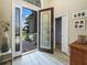 An open foyer featuring a decorative glass front door and sidelights, with tile floors and views to the exterior at 1104 Sawgrass Dr, Winter Haven, FL 33884
