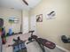 Bright home gym features new equipment, neutral paint and a ceiling fan at 1104 Sawgrass Dr, Winter Haven, FL 33884