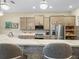 Bright kitchen with an island, wooden cabinets, stainless steel appliances and backsplash, and tile flooring at 1104 Sawgrass Dr, Winter Haven, FL 33884