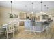 Bright eat-in kitchen features a tile backsplash island with barstool seating and stainless steel appliances at 1104 Sawgrass Dr, Winter Haven, FL 33884