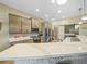 Beautiful kitchen features modern appliances, a breakfast bar, tile floors, and wood cabinets at 1104 Sawgrass Dr, Winter Haven, FL 33884