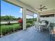 The screened lanai has a dining set and provides a tranquil view of the backyard at 1104 Sawgrass Dr, Winter Haven, FL 33884