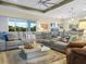 Spacious living room featuring a large sectional sofa, views of the outside, and tile floors at 1104 Sawgrass Dr, Winter Haven, FL 33884