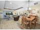 Open living space with tile floors, a tray ceiling, comfortable seating, and seamless access to the kitchen and dining areas at 1104 Sawgrass Dr, Winter Haven, FL 33884