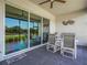 Outdoor patio with ceiling fan and sliding glass doors with a view of the manicured lawn at 1104 Sawgrass Dr, Winter Haven, FL 33884