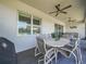 Covered patio features ceiling fans, neutral color tiled flooring, and dining set at 1104 Sawgrass Dr, Winter Haven, FL 33884