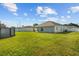 A spacious backyard with green grass and a white fence at 1221 Alameda S Dr, Lakeland, FL 33805