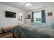 Relaxing bedroom with a comfy bed, TV, and view to the backyard at 1221 Alameda S Dr, Lakeland, FL 33805
