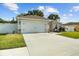 View of the home's exterior showcasing the driveway, garage, and fenced yard at 1221 Alameda S Dr, Lakeland, FL 33805