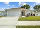 Charming single-story home featuring stone accents, well-kept lawn, and a two-car garage at 1221 Alameda S Dr, Lakeland, FL 33805