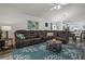 Inviting living room featuring a plush brown sectional sofa and coastal-themed decor at 1221 Alameda S Dr, Lakeland, FL 33805