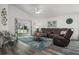 Inviting living room with modern furniture, a ceiling fan, and sliding glass doors at 1221 Alameda S Dr, Lakeland, FL 33805