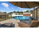 Above-ground pool with a wooden deck and lounge chairs at 1221 Alameda S Dr, Lakeland, FL 33805