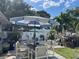 A backyard patio featuring a full-sized umbrella with outdoor dining area at 124 Palm Pl, Haines City, FL 33844