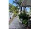The backyard is landscaped with stone pavers, tropical foliage, and a privacy fence at 124 Palm Pl, Haines City, FL 33844