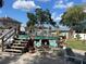Beautiful custom backyard with a custom deck and patio surrounded by tropical landscaping at 124 Palm Pl, Haines City, FL 33844