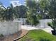 Scenic backyard with a pool, white sandy area, green grass, and tropical foliage at 124 Palm Pl, Haines City, FL 33844