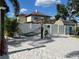 Relaxing backyard featuring a hammock, sandy area, white fence, and lush tropical landscaping at 124 Palm Pl, Haines City, FL 33844