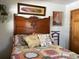 Inviting bedroom featuring a wooden headboard, a patchwork quilt, and charming decor at 124 Palm Pl, Haines City, FL 33844