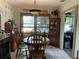 Bright dining room with a round table, wooden chairs, and a vintage-style pendant light at 124 Palm Pl, Haines City, FL 33844