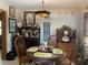 Charming dining room with a glass table, wooden chairs, and unique decorative accents at 124 Palm Pl, Haines City, FL 33844