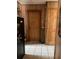 Hallway area with tiled floor, wood paneled walls and wood doors and trim at 124 Palm Pl, Haines City, FL 33844
